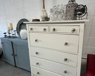 Ikea dresser with Anthopologie mercury glass knobs, decorative objects, vintage lamp. 