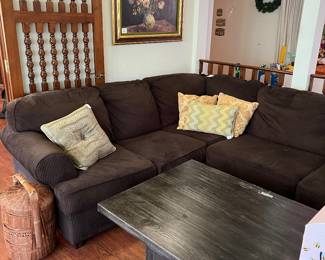 Brown upholstered sectional sofa, coffee table