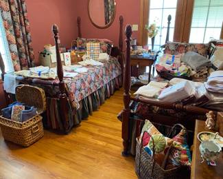 Pair of twin beds in the guest bedroom. They are loaded with nicely folded and ironed linens.