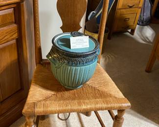 Cute rush seat chair with artist signed lidded pottery piece.