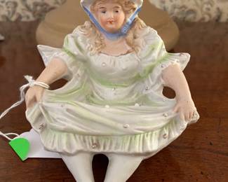 This antique bisque young lady is a naughty one. When she is turned over her posterior is exposed!