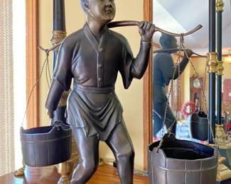 Bronze Asian water boy carrying buckets