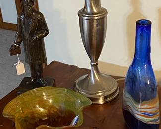 Bronze of the founder of the Salvation Army is to the left of these 2 art glass items.