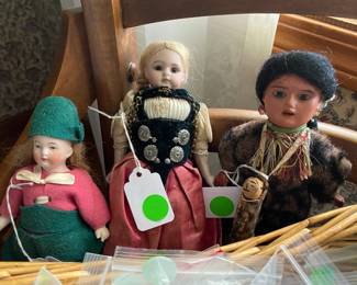 Three small German bisque dolls. The one on the far right is unusual.