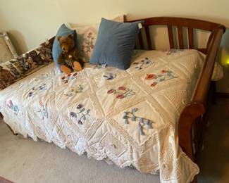 Trundle bed with lovely quilted cover.