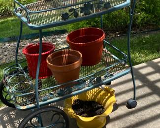 Cute outdoor tea cart type decorative spot for plants and other goodies.