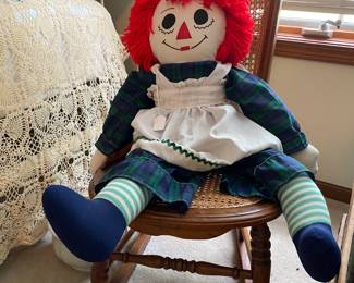 Say "hello" to this large Raggedy Ann. She is sitting pretty in her antique caned rocker.