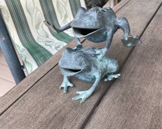 Cute metal frogs leaping.