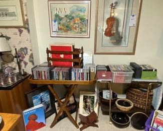 CDs and DVDs - loaded on the left hand side on a neat folding table with a large oval removeable tray. Above it is the Galen Senogles watercolor, "Street Fair", and the signed Walter Hatke giclee print," Music: Ladder to the Soul"