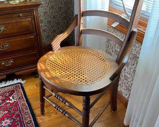 Cute caned seat chair in master bedroom
