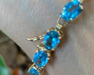 #85 - $285 - 10kt yellow gold 7 1/2" blue topaz bracelet 8.8 grams. 