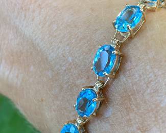 #85 - $285 - 10kt yellow gold 7 1/2" blue topaz bracelet 8.8 grams. 