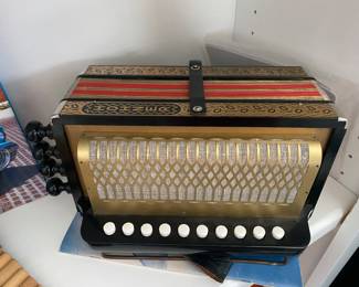 #23 - $300 Hohner diatonic accordion with box. 