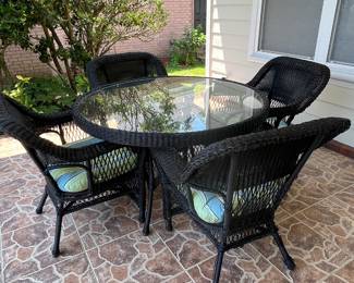 $450 set of all weather round wicker glass top table 51W x 31H and 4 chairs with cushions 30 W x 20D x 37 H