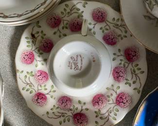 Bottom side of white and pink floral ceramic teacup and saucer 