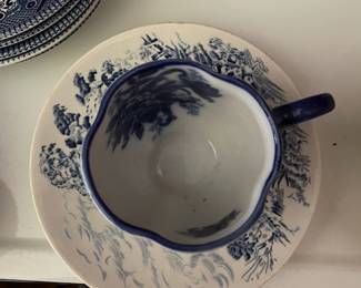 Blue and white ceramic cup and matching saucer 