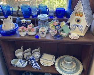 One entire shelf of glassware, ceramics, blue glass cups in sunroom