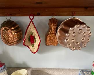 Decorative textured copper bowls hanging in kitchen 