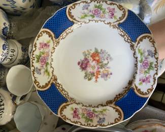 Blue and white ceramic plate with orange, pink floral design and gold details 