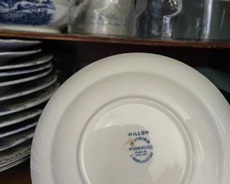 Bottom side of intricate white and blue ceramic plate in kitchen 