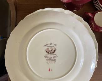 Bottom side of white scalloped autumnal themed plate in office 