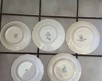 Bottom side of 5 examples of ceramic plates that are in kitchen cabinets