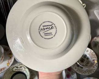 Bottom side of white, textured, radial fruit pattern shallow ceramic dish