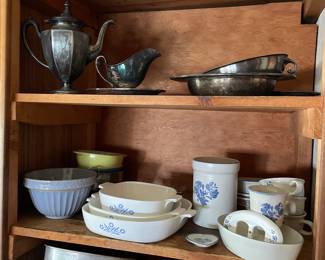 One kitchen cabinet of metal/glass pans, metal gravy boats, decorative ceramic bowls/cups