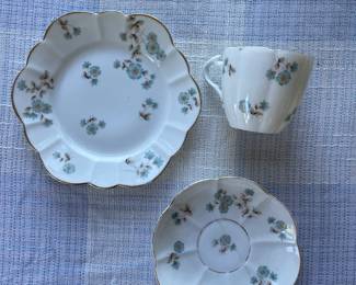 Small white, floral saucers and cup with gold details 