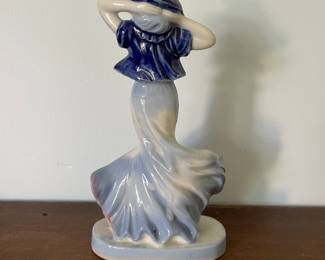 Backside of ceramic white and blue statue of woman 