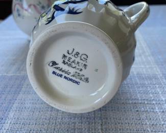 Bottom side of white and blue ceramic gravy boat 