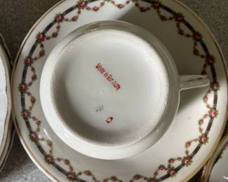 Bottom side of gold, green, pink, plant pattern plate and mug 