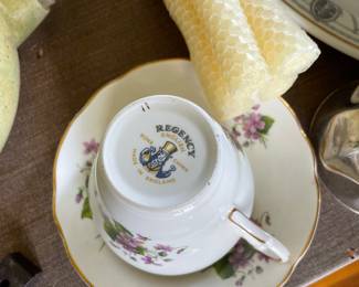 Bottom side of white, light purple floral ceramic teacup 