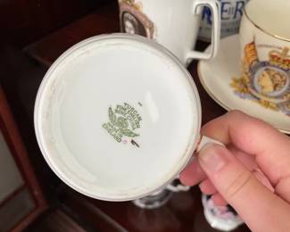 Bottom side of Royal family collectable ceramic dishware, with faces and dates 