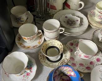 Assorted decorative tea cups and saucers 