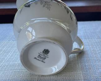 Bottom side of small white, floral gravy boat with gold details