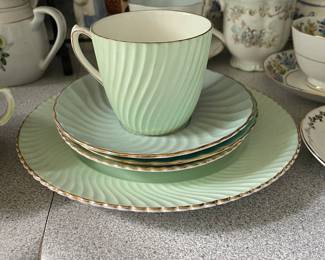 Light green textured tea cup and saucers with gold detail