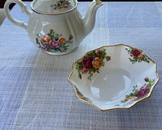Small white, floral teapot and saucer with gold details