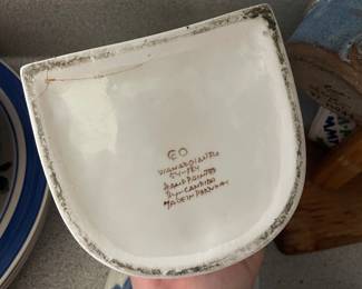 Bottom side of white and blue floral jar 