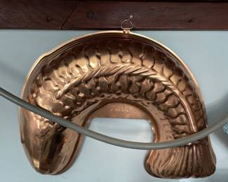 Unique fish-shaped textured brass dish in kitchen 
