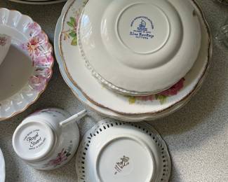 Bottom side of assorted ceramic floral design plates, cup in kitchen 