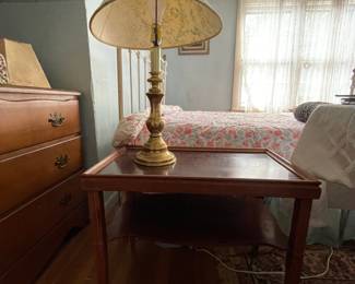 Wooden side table and gold lamp in upstairs bedroom 
