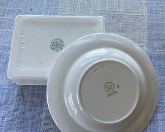Bottom side of shiny white dish, container with 3D blue floral patterns 