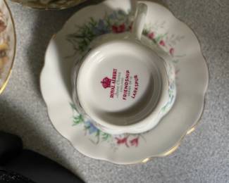 Bottom side of white and multicolored floral ceramic teacup and saucer 