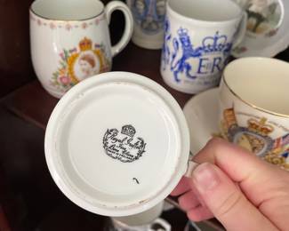 Bottom side of Royal family collectable ceramic dishware, with faces and dates 
