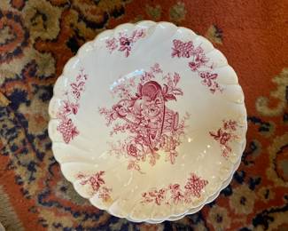 White ceramic scalloped plate with red floral designs 