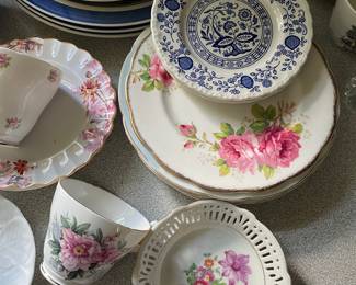 Assorted ceramic floral design plates, cup in kitchen 
