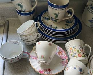 Assorted floral ceramic cups and plates in kitchen 