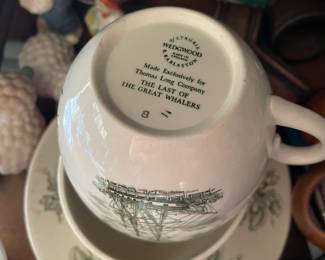 Bottom side of white and green decorated ceramic cups and plate 