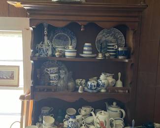Entire top shelves of ceramic dishware in den 